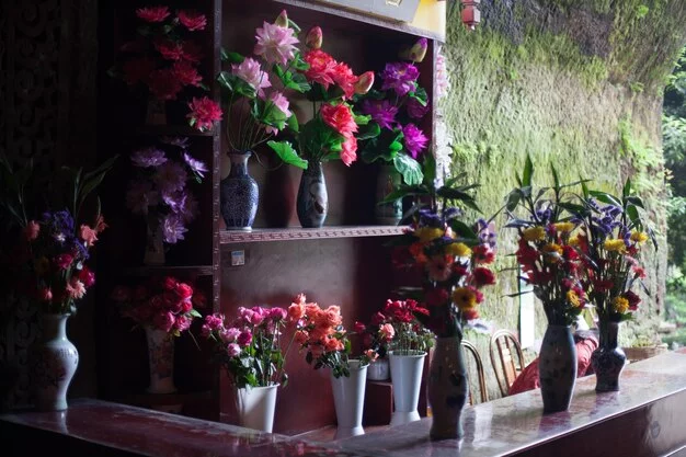 Colorful display of flowers in an urban market setting.